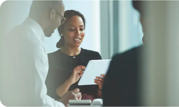 Woman on ipad talking to colleague Best Practice in Biomarker Testing